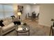 Bright living area flowing into a dining space, featuring stylish decor and wood-look floors at 1913 W Saint Conrad St, Tampa, FL 33607