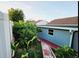 Backyard landscaping with lush greenery, and a red brick walkway at 1918 Crown Park Dr, Valrico, FL 33594