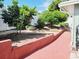 Landscaped backyard with trees, brick-lined garden, and a red brick walkway at 1918 Crown Park Dr, Valrico, FL 33594