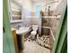 Cozy full bathroom showcasing tiled walls, a pedestal sink, toilet, and a shower with shower curtain at 1918 Crown Park Dr, Valrico, FL 33594