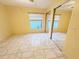 Bright bedroom with tile floors, window, and closet with sliding mirrored doors at 1918 Crown Park Dr, Valrico, FL 33594