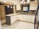 Modern kitchen with white cabinets, countertops, and mosaic tile backsplash at 1918 Crown Park Dr, Valrico, FL 33594