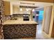 Well-lit kitchen with stainless steel appliances, mosaic backsplash, island, and plenty of cabinet space at 1918 Crown Park Dr, Valrico, FL 33594