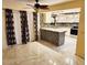 Kitchen with island, stainless steel appliances, and tile flooring with decorative curtains at 1918 Crown Park Dr, Valrico, FL 33594