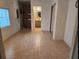 Spacious living room featuring neutral walls, tiled floors, and doors to the kitchen and bathroom at 1918 Crown Park Dr, Valrico, FL 33594
