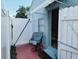 Private outdoor patio area with a comfortable chair, enclosed by a white fence at 1918 Crown Park Dr, Valrico, FL 33594