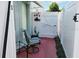 Cozy patio features an outdoor chair, small table, decorative plants, and white picket fence at 1918 Crown Park Dr, Valrico, FL 33594