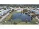 Aerial view of condo complex showing pond with water feature and surrounding landscape and neighborhood at 1921 58Th N Ave # 15, St Petersburg, FL 33714