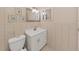 Neutral-toned bathroom featuring a white vanity with a white sink, square mirror, and tiled walls at 1921 58Th N Ave # 15, St Petersburg, FL 33714
