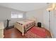 Cozy bedroom featuring wood floors and a comfortable bed with natural light from the window at 1921 58Th N Ave # 15, St Petersburg, FL 33714