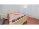 Comfortable bedroom with wood floors, a bed with a patterned quilt, and a white nightstand at 1921 58Th N Ave # 15, St Petersburg, FL 33714