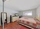 Bedroom with wood floors, a bed with a patterned quilt, dresser, and natural light from the window at 1921 58Th N Ave # 15, St Petersburg, FL 33714