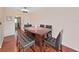Dining area features wood table with bar stools and dark hardwood floors at 1921 58Th N Ave # 15, St Petersburg, FL 33714