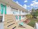 Charming two-story condo with bright teal doors and white railings and steps at 1921 58Th N Ave # 15, St Petersburg, FL 33714