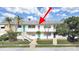 View of building exterior featuring bright teal doors, steps, and tropical foliage at 1921 58Th N Ave # 15, St Petersburg, FL 33714