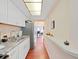 Well-lit kitchen with white cabinets, stainless steel appliances, and hardwood flooring at 1921 58Th N Ave # 15, St Petersburg, FL 33714