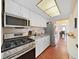 Modern kitchen with stainless steel appliances, granite countertops, and hardwood flooring at 1921 58Th N Ave # 15, St Petersburg, FL 33714