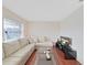 Cozy living room featuring a plush sofa, hardwood floors, and ample natural light at 1921 58Th N Ave # 15, St Petersburg, FL 33714