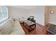 Bright living room with a large sectional sofa, hardwood floors and a media center at 1921 58Th N Ave # 15, St Petersburg, FL 33714