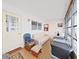 Bright sunroom featuring neutral colors, a small sofa, blue chair, lots of windows, and vinyl wood-look floors at 1921 58Th N Ave # 15, St Petersburg, FL 33714