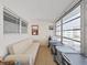 Bright sunroom featuring neutral colors, a sofa, lots of windows with outside view, and vinyl wood-look floors at 1921 58Th N Ave # 15, St Petersburg, FL 33714
