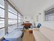 Bright sunroom with large windows, ample storage containers, and a comfortable seating area at 1921 58Th N Ave # 15, St Petersburg, FL 33714