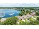 Aerial view of a lakeside community showing houses with lush landscaping at 2527 Butterfly Landing Dr, Land O Lakes, FL 34638