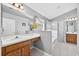 Bathroom features dual sinks, soaking tub, walk-in shower and bright light fixtures at 2527 Butterfly Landing Dr, Land O Lakes, FL 34638