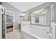 Bathroom shows soaking tub, shower, vanity, and tile floors at 2527 Butterfly Landing Dr, Land O Lakes, FL 34638