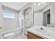 Bright bathroom with a window over the tub and a door to the outside patio at 2527 Butterfly Landing Dr, Land O Lakes, FL 34638