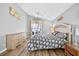 Bright bedroom with ceiling fan, wood floors, and sliders to a patio at 2527 Butterfly Landing Dr, Land O Lakes, FL 34638