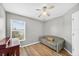 Bedroom shows wood floors, ceiling fan, window with blinds, and sofa at 2527 Butterfly Landing Dr, Land O Lakes, FL 34638