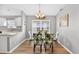 Bright dining room featuring wood-look floors, a modern chandelier, and natural light at 2527 Butterfly Landing Dr, Land O Lakes, FL 34638