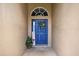 Inviting front entrance with a blue door, welcome sign, and decorative wreath at 2527 Butterfly Landing Dr, Land O Lakes, FL 34638
