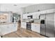Open kitchen featuring stainless steel appliances, granite countertops, and wood-look floors at 2527 Butterfly Landing Dr, Land O Lakes, FL 34638