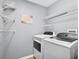 Organized laundry room featuring a washer, dryer, and shelving for storage at 2527 Butterfly Landing Dr, Land O Lakes, FL 34638