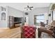 Cozy living room with hardwood floors, bright natural light, and a view of a screened-in porch at 2527 Butterfly Landing Dr, Land O Lakes, FL 34638