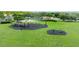 Aerial view of a large community playground with swings, climbing area, and fitness equipment at 2527 Butterfly Landing Dr, Land O Lakes, FL 34638