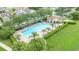 Aerial view of a community swimming pool, lounge chairs, landscaping, and surrounding homes at 2527 Butterfly Landing Dr, Land O Lakes, FL 34638