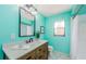 Bright bathroom featuring wood vanity, updated fixtures, and clean, modern design at 2609 Sunnyside Cir, Palm Harbor, FL 34684