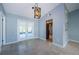 Dining area featuring stylish light fixture, neutral walls, and sliding glass doors leading to the lanai at 2609 Sunnyside Cir, Palm Harbor, FL 34684