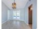 Dining area featuring stylish light fixture, neutral walls, and sliding glass doors leading to the lanai at 2609 Sunnyside Cir, Palm Harbor, FL 34684