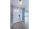 Clean entryway showcasing neutral tile flooring, a glass-paneled front door, and calming gray walls at 2609 Sunnyside Cir, Palm Harbor, FL 34684