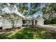 Charming single-story home with a well-manicured lawn and mature trees, offering great curb appeal at 2609 Sunnyside Cir, Palm Harbor, FL 34684
