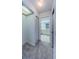Hallway with light carpet and doors leading to a closet and bathroom for a comfortable living space at 2609 Sunnyside Cir, Palm Harbor, FL 34684