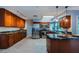 Spacious kitchen features stainless appliances, brown cabinets, tile floor, and marble countertops at 2609 Sunnyside Cir, Palm Harbor, FL 34684