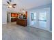 Kitchen featuring stainless appliances, brown cabinets, and access to outdoor space at 2609 Sunnyside Cir, Palm Harbor, FL 34684