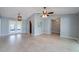 Spacious living area with ceramic tile flooring, ceiling fan, and access to the lanai through French doors at 2609 Sunnyside Cir, Palm Harbor, FL 34684