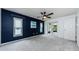 Comfortable main bedroom with an accent wall, plush carpet, and glass doors opening to a patio at 2609 Sunnyside Cir, Palm Harbor, FL 34684