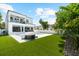 Backyard view featuring a pool with a hot tub, and a seating area on the lawn at 2707 Ridgewood Ave, Tampa, FL 33602